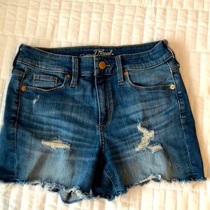DISTRESSED HIGH RISE DENIM SHORTS